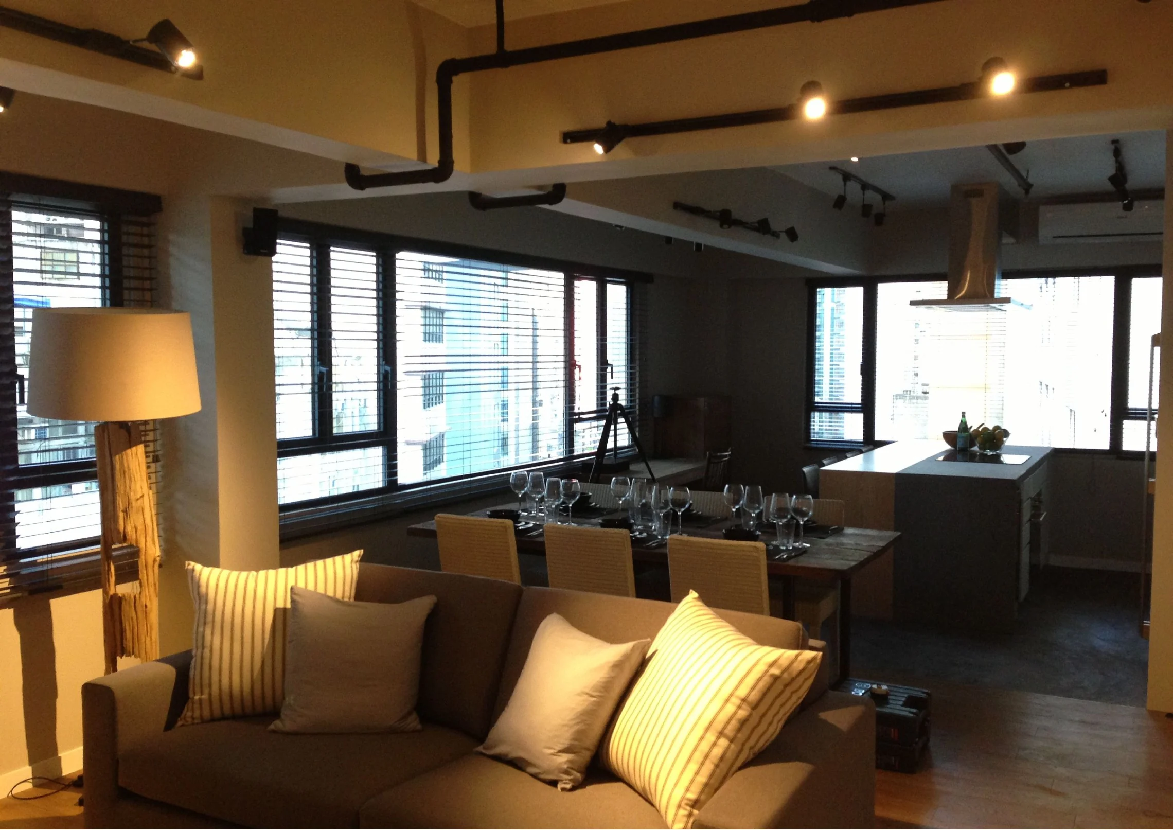 Living and dining area in a Central home, with timber flooring and layered lighting