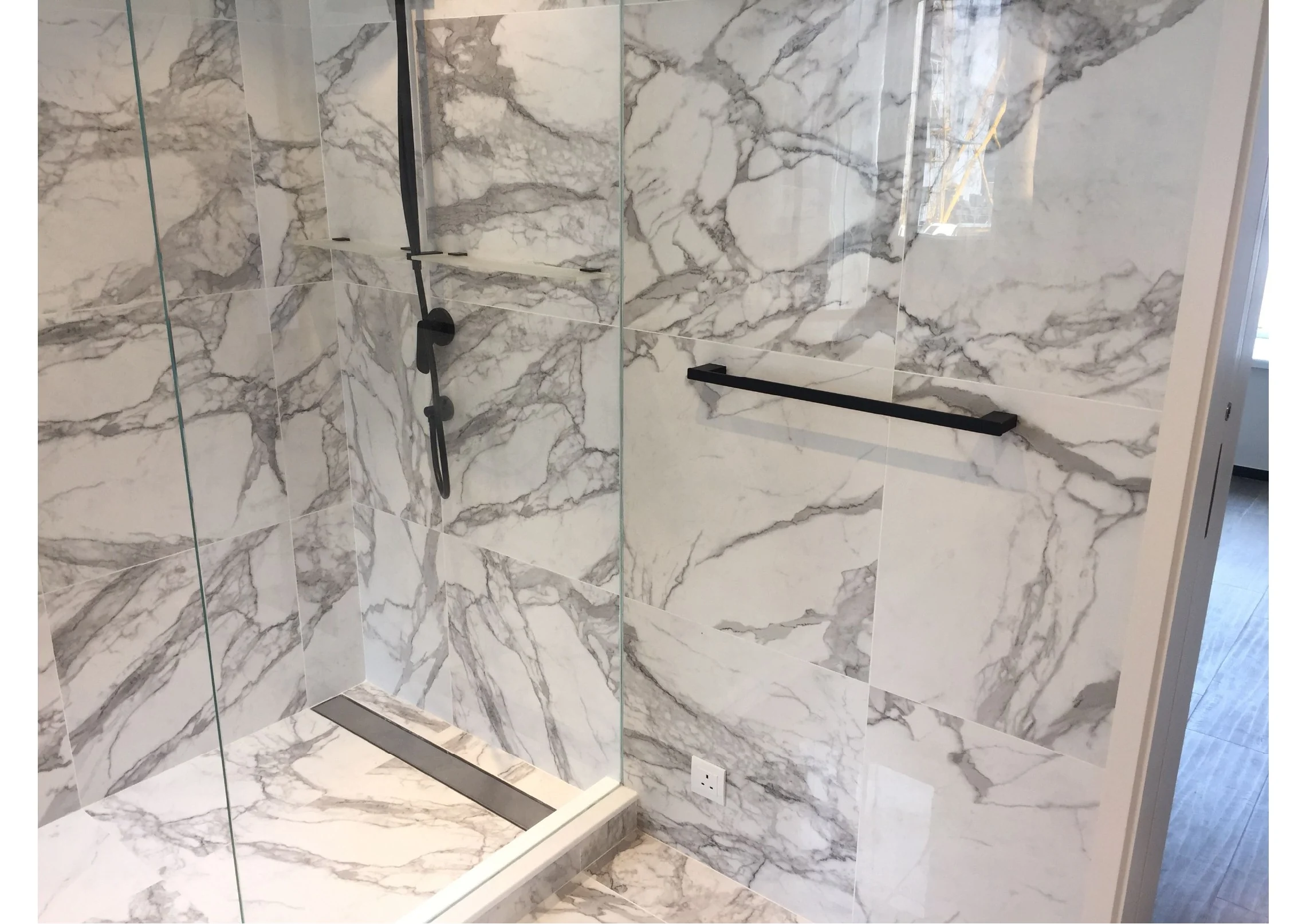 Close view of stone finishes and the shower threshold