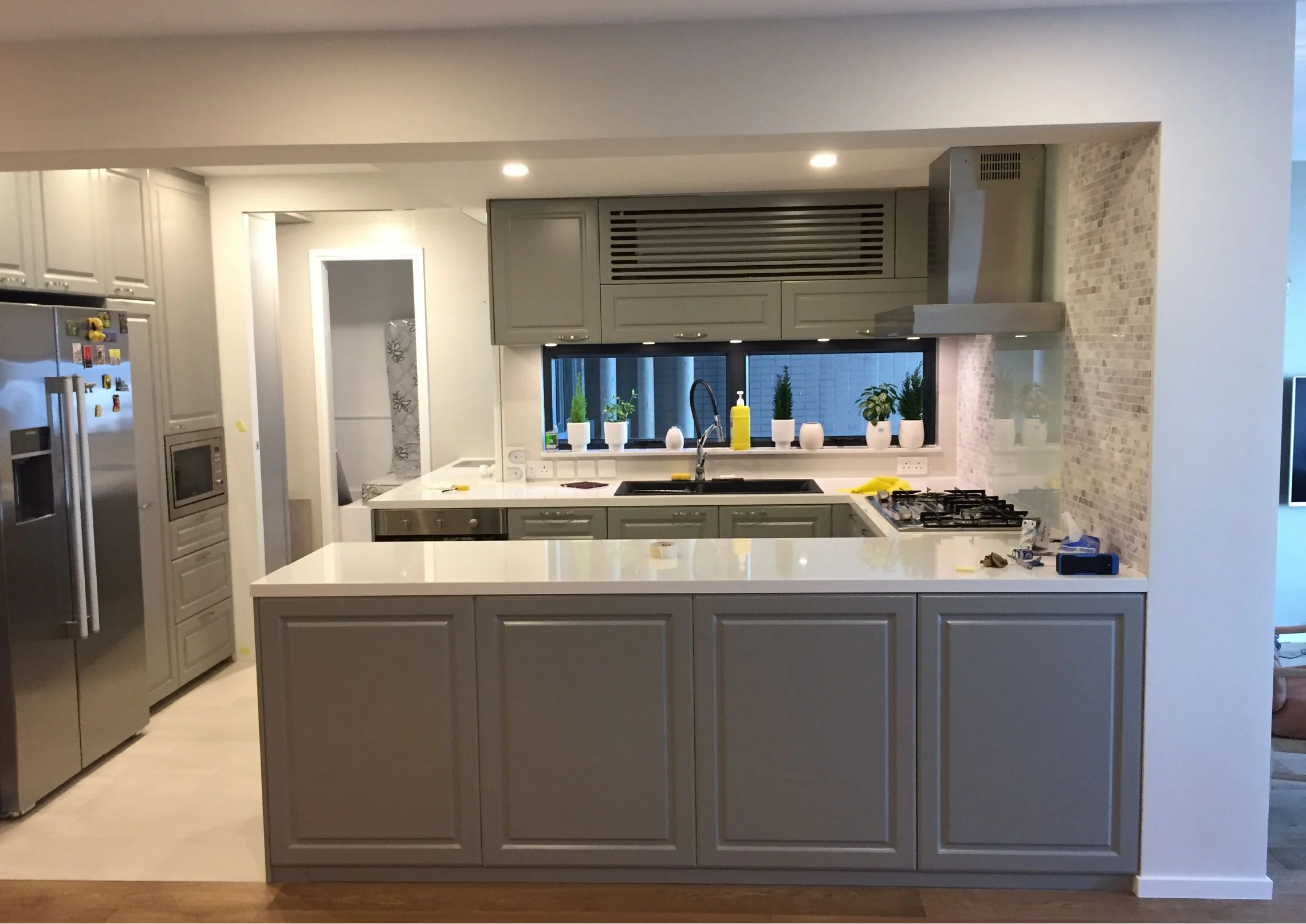 Full view of the Mid-Levels kitchen island and grey cabinetry