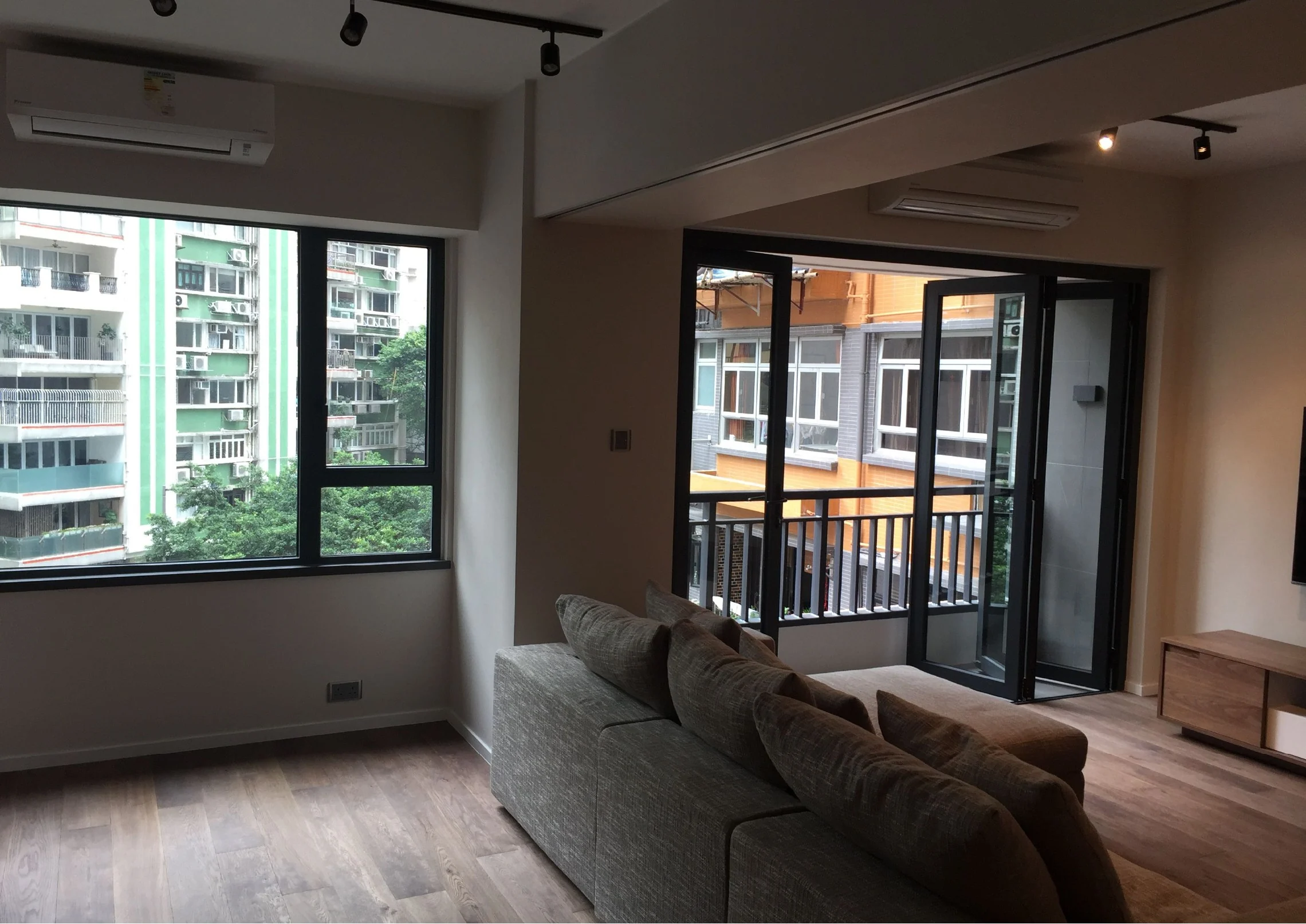 Seating area and balcony doors in a connected Mid-Levels living space