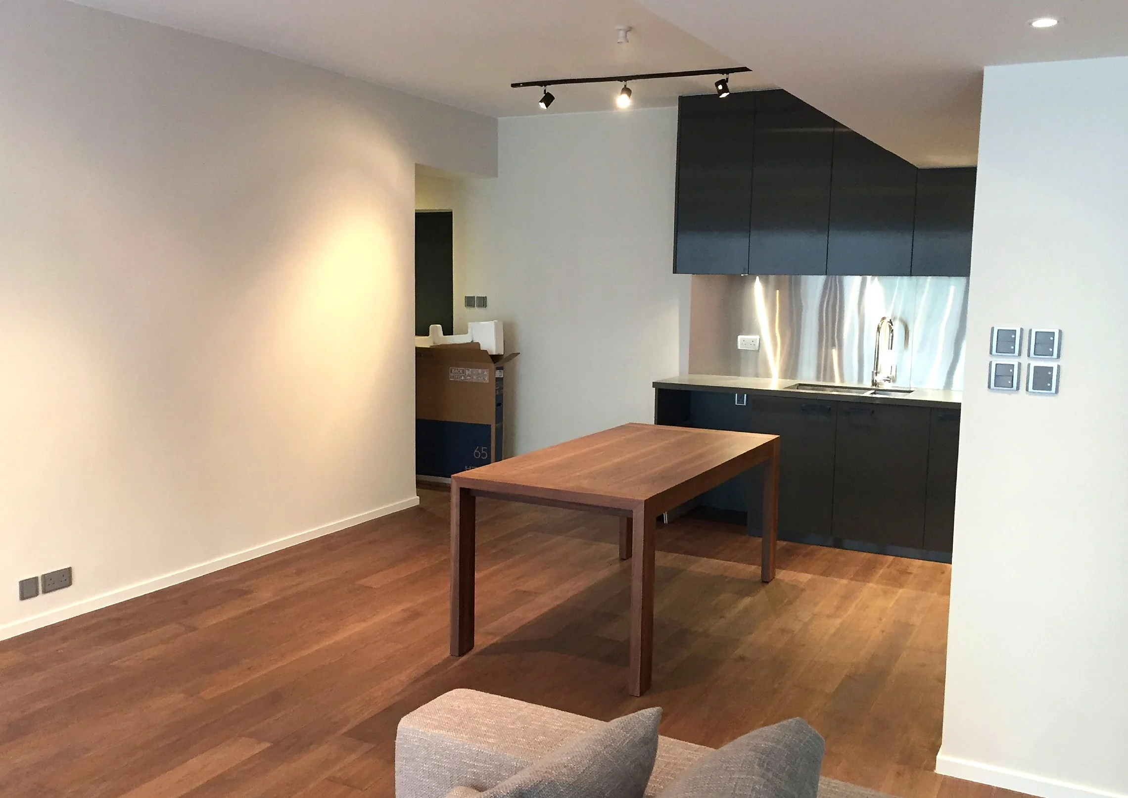 Open-plan living and dining space with warm timber flooring in the Mid-Levels
